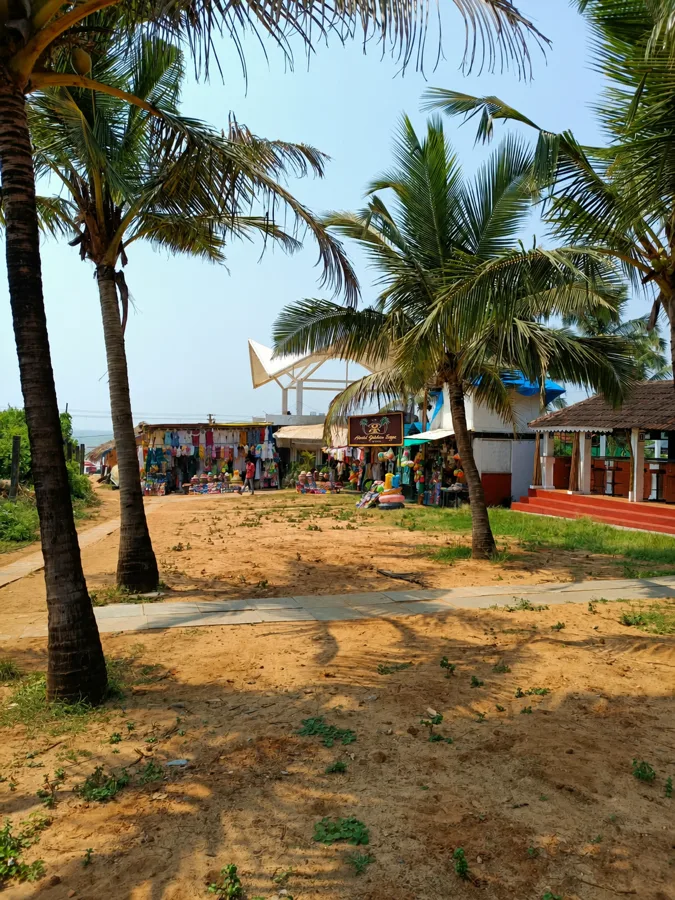 The sandy garden lane leading west towards Calangute beach.
